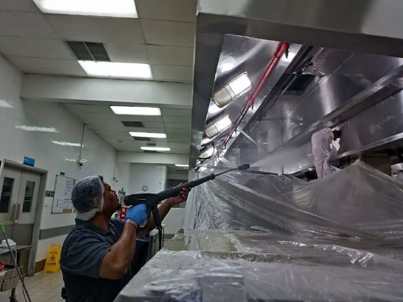 SGH technician degreasing a commercial kitchen exhaust hood