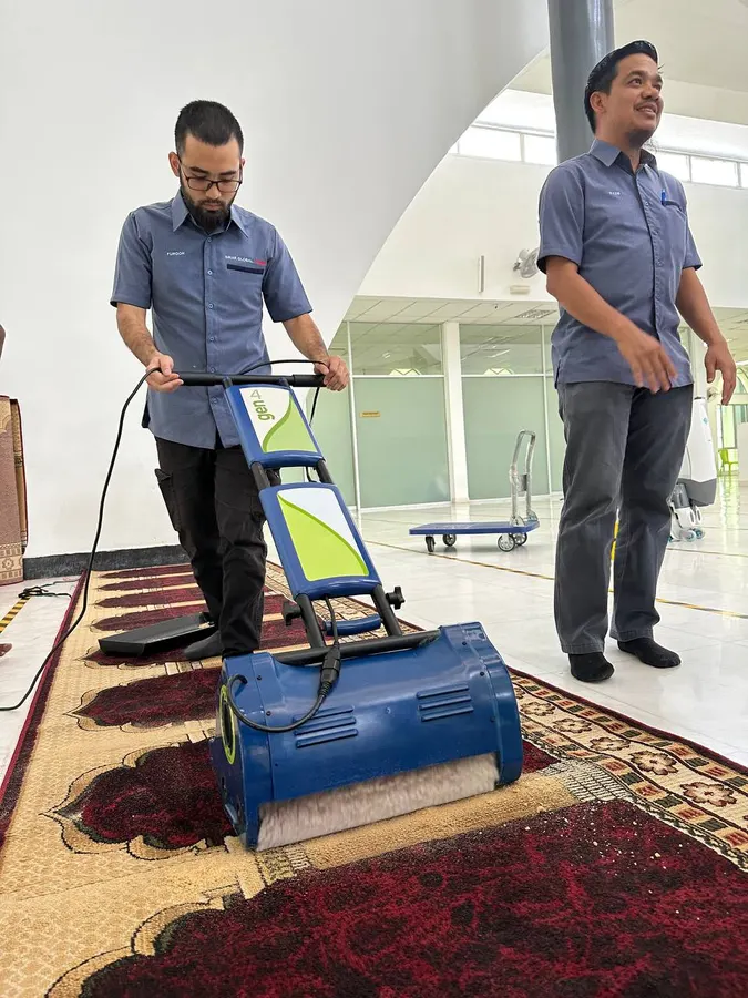 SGH team using a scrubber machine on a mosque carpet