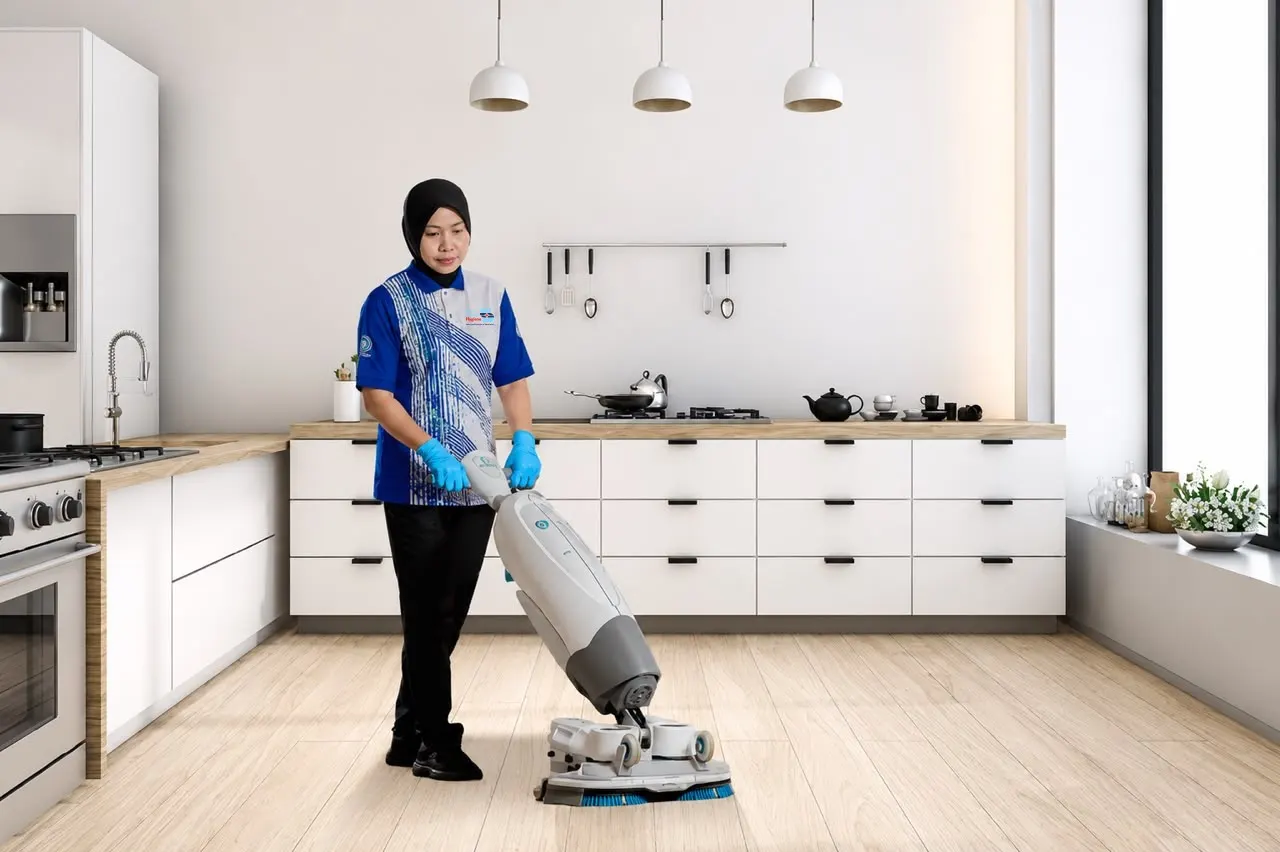Staff member mopping a modern kitchen floor